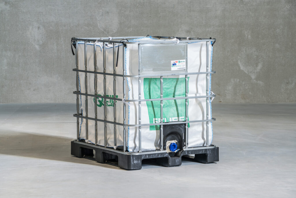 Flexible aseptic 1000 litre bag inside a metal cage on a pallet