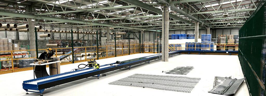 Additional warehouse space added by Industrial Packaging via a mezzanine with conveyor belt to stock fibre drums and other industrial containers